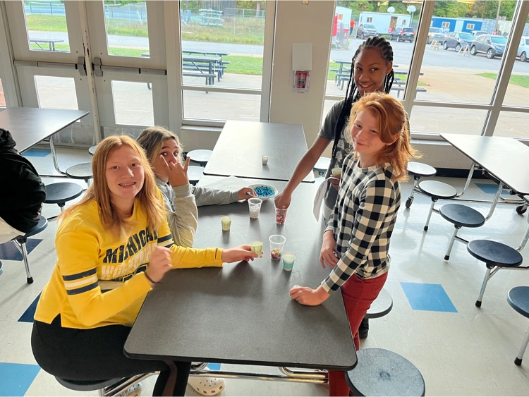 Students posing for photos in cafeteria
