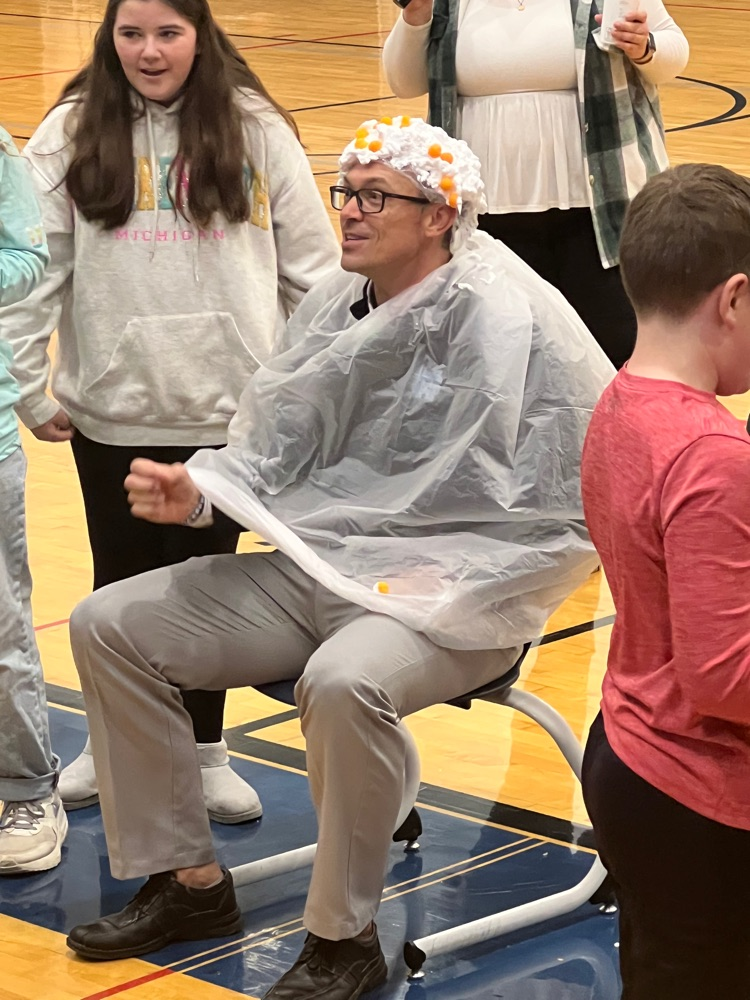 Mr. Ammeraal with shaving cream and cheese balls on his head